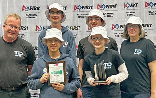 At the Oklahoma regional, the team received the Rookie All Star Award and was selected as the one of the wildcards to attend the worlds competition in Houston, Texas. Displaying the awards from front left, Lincoln Southeast student Juan McKendry and Aurora student Ella Curtis. Back from left, Aurora FRC mentor Marcus Brandl, Aurora students Thomas Brandl, Austin Lents and Aurora FRC coach, Tami Brown-Brandl.